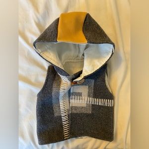 Handmade wool and leather vest with hood.